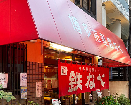 大きな赤い看板のある鉄なべ餃子の外観
